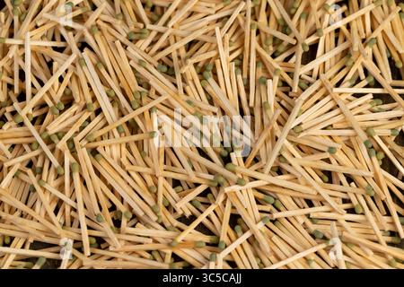 wooden matches scattered in a large pile, scattered wooden matches without matchboxes on the table, close up, side view Stock Photo