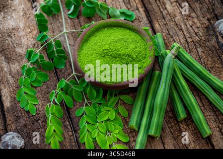 Moringa oleifera powder, Drumstick leaf powder on wooden background ...
