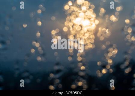 Golden light refracts through water, creating a mesmerizing abstract pattern. Stock Photo