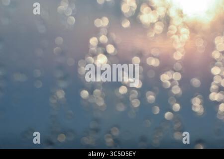 Golden light refracts through water, creating a mesmerizing abstract pattern. Stock Photo