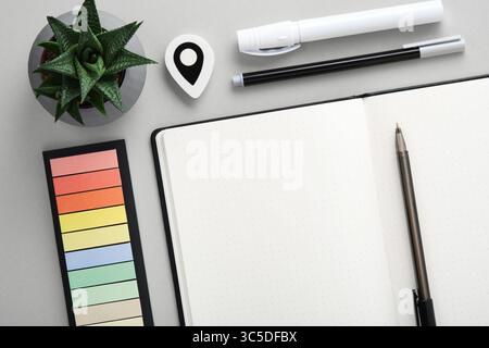 Empty notebook page for your text with black and white school and office stationery on gray background. Flatly. Stock Photo