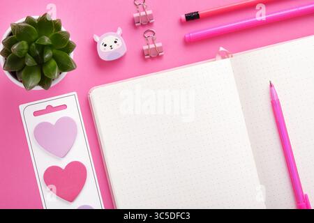 Piece of empty notebook page for your text in frame of pink color stationery. Heart-shaped stickers Stock Photo