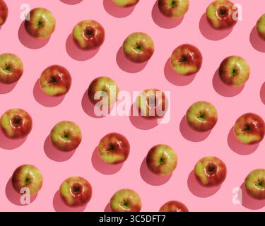 Autumn fruit pattern of fresh red apples on pink background, top view Stock Photo