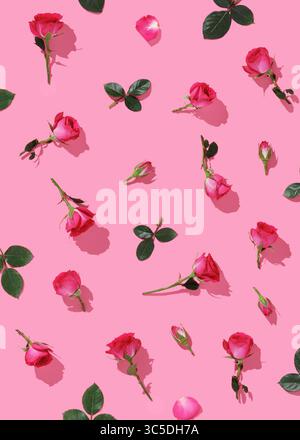 Floral background with pink roses and green leaves. Flatlay. Pattern of flowers. Stock Photo