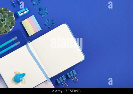 Knolling composition with different school stationery on blue background. Back to school Stock Photo