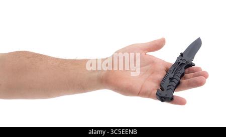 Hand holds a black folding knife in studio light Stock Photo