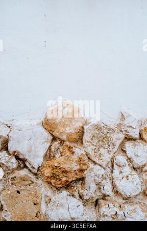 Old textured wall with stone base and stucco top Stock Photo
