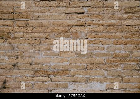 Close-up of tan weathered brick wall texture Stock Photo