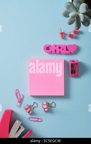Banner of pink sticky notes and office supplies stapler, paper clips, sharpener, eraser, pins. Copyspace. Stock Photo
