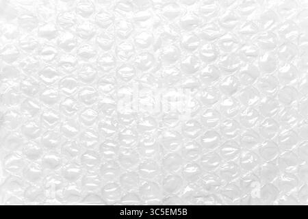 Transparent packaging bubble wrap on white table. Abstract background. Soft protective material Stock Photo