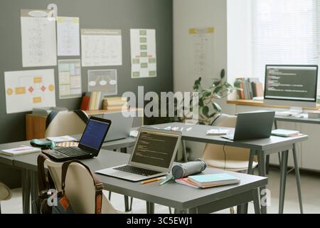 Empty Classroom with Laptops Displaying Code Awaiting Students Arriving Stock Photo