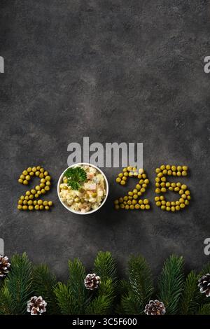 Vertical banner with numbers of new year 2025 and Russian olivier salad on dark background. Place for your text. Stock Photo