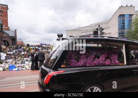 The family of Ozzy Osbourne (left to right) Kelly, Sharon and Jack Osbourne, view the messages and floral tributes left at the Black Sabbath Bridge bench on Broad Street in Birmingham in memory of Black Sabbath frontman Ozzy Osbourne, as his body is brought back to his home city for a procession following his death last week aged 76. Picture date: Wednesday July 30, 2025. Stock Photo