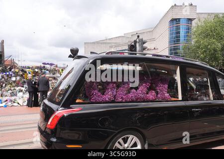 The family of Ozzy Osbourne (left to right) Kelly, Sharon and Jack Osbourne, view the messages and floral tributes left at the Black Sabbath Bridge bench on Broad Street in Birmingham in memory of Black Sabbath frontman Ozzy Osbourne, as his body is brought back to his home city for a procession following his death last week aged 76. Picture date: Wednesday July 30, 2025. Stock Photo