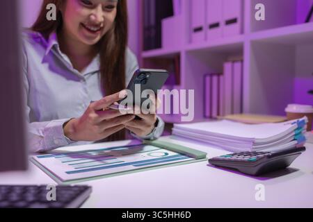 a businesswoman works overtime at her company to finish important documents in time for a business cooperation contract signing tomorrow, tired, overw Stock Photo