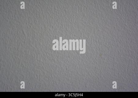 White painted wall texture with grainy finish – minimalist neutral background Stock Photo