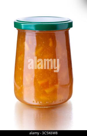 Orange marmalade in a glass jar with a green cap isolated on white with clipping path included Stock Photo