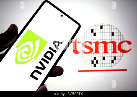 In this photo illustration, the Nvidia logo is seen displayed on a smartphone with a TSMC(Taiwan Semiconductor Manufacturing Company) logo in the background. Stock Photo