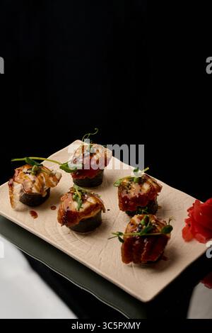 japanese cuisine. Sushi on a plate on a black background Stock Photo