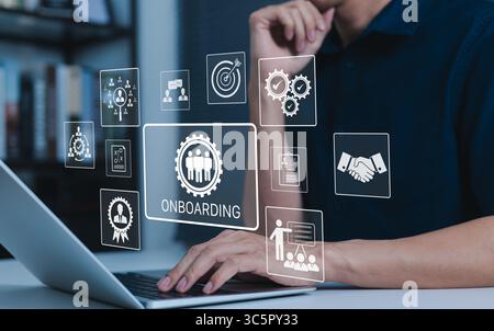 Onboarding New Employee Process Concept. Person working on laptop with icons representing the onboarding process, human resources, training, employee Stock Photo
