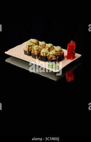 japanese cuisine. Sushi on a plate on a black background Stock Photo