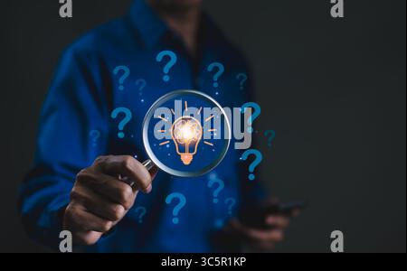 The concept of using creative thinking to help solve problem. Innovation patent, Find solution, think idea, Businessman holding magnifying glass icon Stock Photo