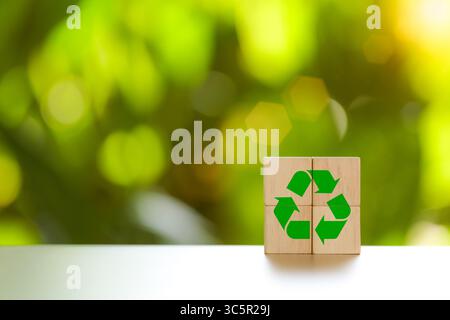 Recycle concept. Green recycle symbol label on wooden block. ecological to save the earth and sustainable development. Responsible business, Ecology s Stock Photo