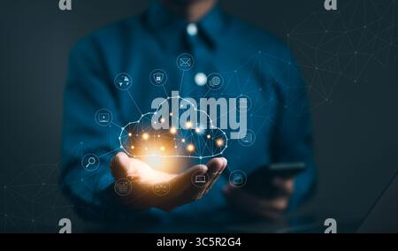 Cloud computing technology concept. Businessman hand holding cloud computing icon network. download and information upload on application system. data Stock Photo