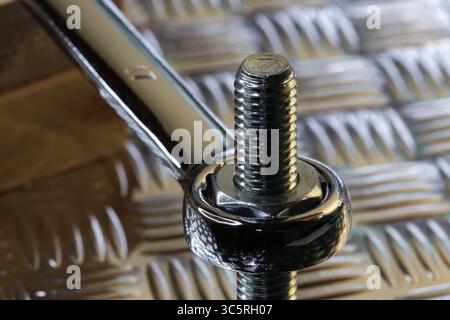 Tightening Nut On Bolt With Chrome Spanner Stock Photo