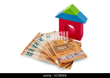 Multicolored toy brick houses on fifty euro banknotes isolated on white with clipping path included, concept of house purchase cost Stock Photo