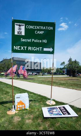Burlington, Massachusetts, USA. 30 July 2025. 15th Weekly ‘Bearing Witness’ demonstration outside of a New England facility of Immigration and Customs Enforcement (ICE) in Burlington.  The facility, 16miles (26km) northwest of Boston, holds people detained by ICE in the states of Rhode Island, Connecticut, Massachusetts, New Hampshire, Maine and Vermont. Hundreds took part in the weekly demonstration against ICE, Donald Trump and his current administration outside of the facility. Sign placed on the sidewalk at the entrance to the facility, right of frame. Credit: Chuck Nacke/Alamy Live News Stock Photo