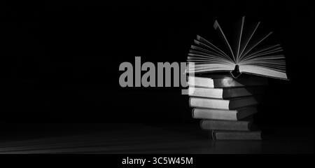 open book and stack of books,reading, education, knowledge is power concept. Stock Photo