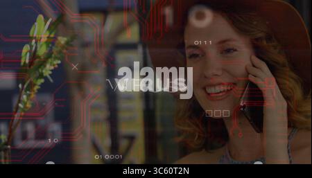 Talking woman using smartphone at right ear in server room, with virus code overlay, copy space Stock Photo