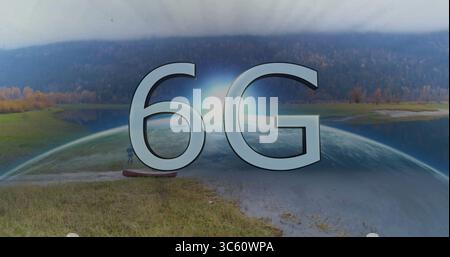 Displaying transparent Earth globe overlay and 6G text occupying center at lakeside, with red canoe Stock Photo