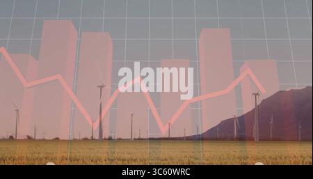 Displaying wind turbines spanning grassy field at mountain base, with translucent financial overlay Stock Photo