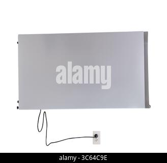 A gray refrigerator or fridge plugged into the wall socket is isolated on white background with clipping path. Stock Photo