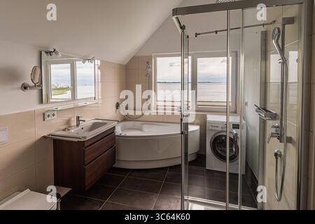Modern bathroom in natural colors with view to the sea Stock Photo