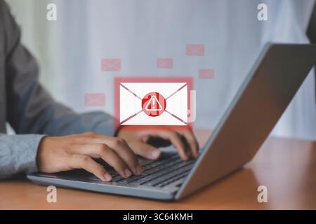 Laptop showing spam notification on screen, anti spam email concept Stock Photo