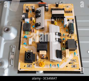 Close-up view of an electronic circuit board featuring various components such as capacitors, resistors, and connectors. The image highlights the intr Stock Photo