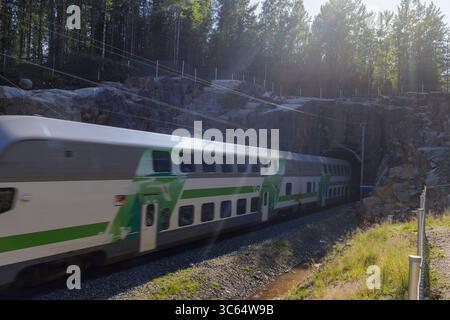 Long-distance Pendolino passenger train entering railroad tunnel , Finland Stock Photo