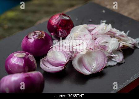 Sliced red onion on black wooden background Stock Photo