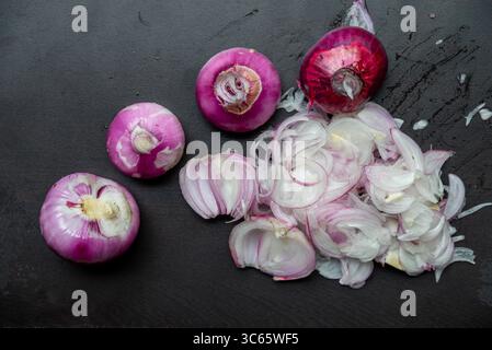 Sliced red onion on black wooden background Stock Photo