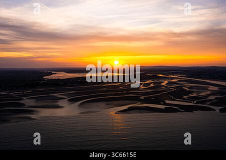 Golden Hour Aerial of Portrane Beach at Low Tide With a Beautiful Sunset at the Horizon Stock Photo