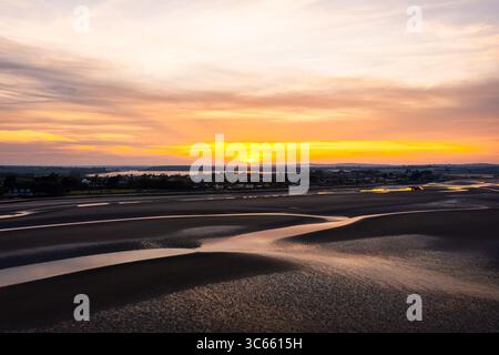 Golden Hour Aerial of Portrane Beach at Low Tide With a Beautiful Sunset at the Horizon Stock Photo