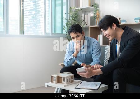 Creative Collaboration. Architects discussing building model and project ideas. Stock Photo