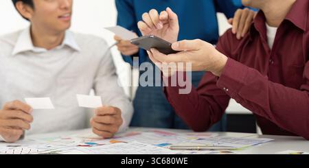 UX and UI Team Discussing Design Ideas with Smartphone Stock Photo