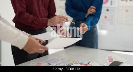 UX and UI Design Team Reviewing Concepts in Meeting Stock Photo