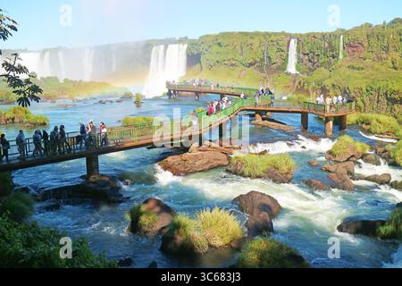Stunning Brazilian Side Iguazu Falls with Large Group of Visitor on the Boardwalk, Foz do Iguacu Town, Brazil, South America Stock Photo