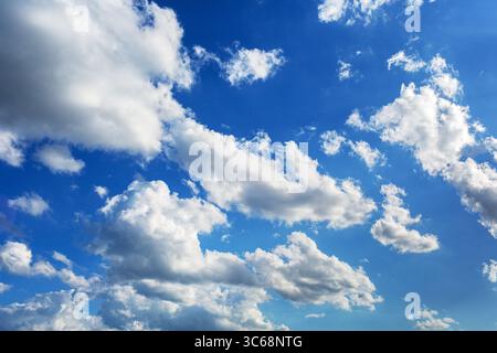 White fluffy serene clouds float across the sky giving a feeling of calm and solitude Stock Photo