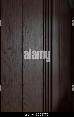 Close-up view of dark brown wood. Brown wooden louvers inside a dark room with grooves that look almost like barcode. Stock Photo